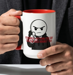 A person is holding a white mug with a red rim, which features a cartoon character and the text "REEMEMBER - anything you say, could be used against you!"