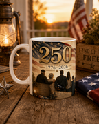 A white mug with an American flag design and the number "250" printed on it, placed on a wooden surface.