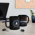 two black mugs with space-themed designs, placed on a desk with a laptop, a plant, and some office supplies.
