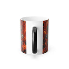 A white ceramic mug with a black handle, featuring a vibrant design of flames and other abstract shapes.