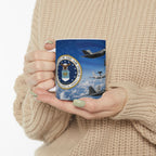 A person is holding a mug with an image of airplanes and the United States Air Force seal on it.