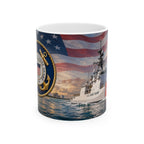 A mug featuring a design of a U.S. Coast Guard ship sailing on the water, with an American flag in the background and a nautical emblem on the side.