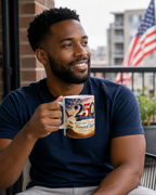A man with a beard is sitting on a balcony, holding a mug with an image of an American flag and the text "250th Anniversary of the Battle of Fort Sumter".
