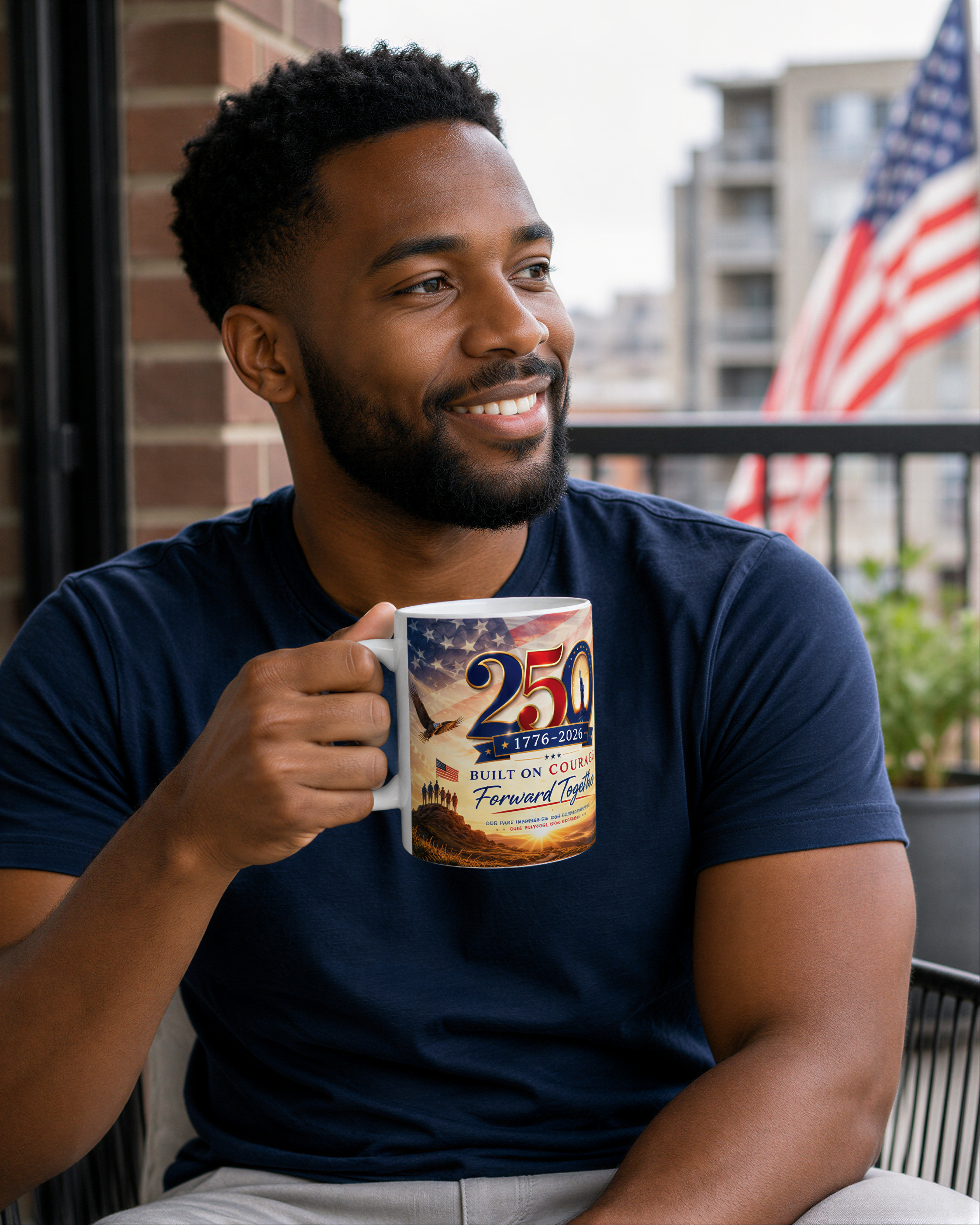 A man with a beard is sitting on a balcony, holding a mug with an image of an American flag and the text "250th Anniversary of the Battle of Fort Sumter".
