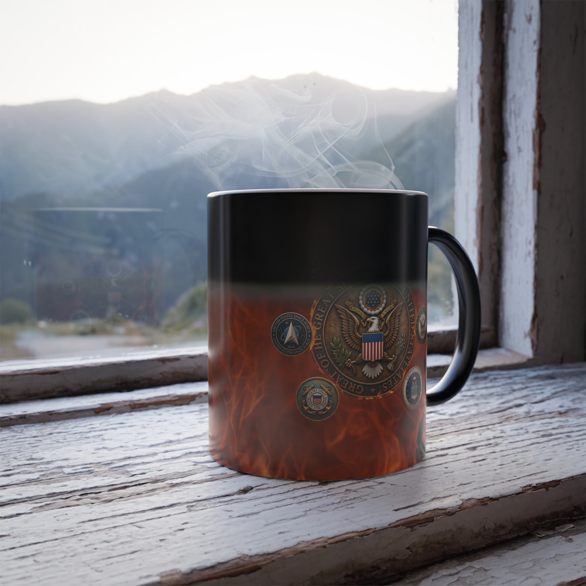 A black and orange mug with a design featuring the United States seal and various military insignia, placed on a wooden windowsill with a mountain landscape visible through the window.