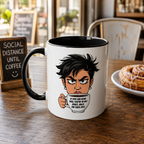 A white coffee mug with a cartoon character holding a coffee cup, accompanied by text that reads "If you can read this, you're in my space, back. The fuck off." The mug is placed on a wooden table, with a plate of pastries and a chalkboard sign visible in the background.