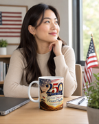 A woman sits at a desk, looking thoughtfully to the side, with a mug featuring a design celebrating the 250th anniversary of the United States.