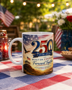 A white mug with a patriotic design celebrating the 250th anniversary of the United States, featuring an American flag, eagle, and text that reads "Built on Courage Forward Together".