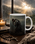 A mug with a knight in armor kneeling in front of a window, with a candle and rosary nearby, and a book titled "HOLY BIBLE" on a table.