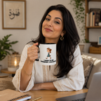 A woman is sitting at a desk, holding a mug with a cartoon character on it. She is smiling and appears to be enjoying herself.