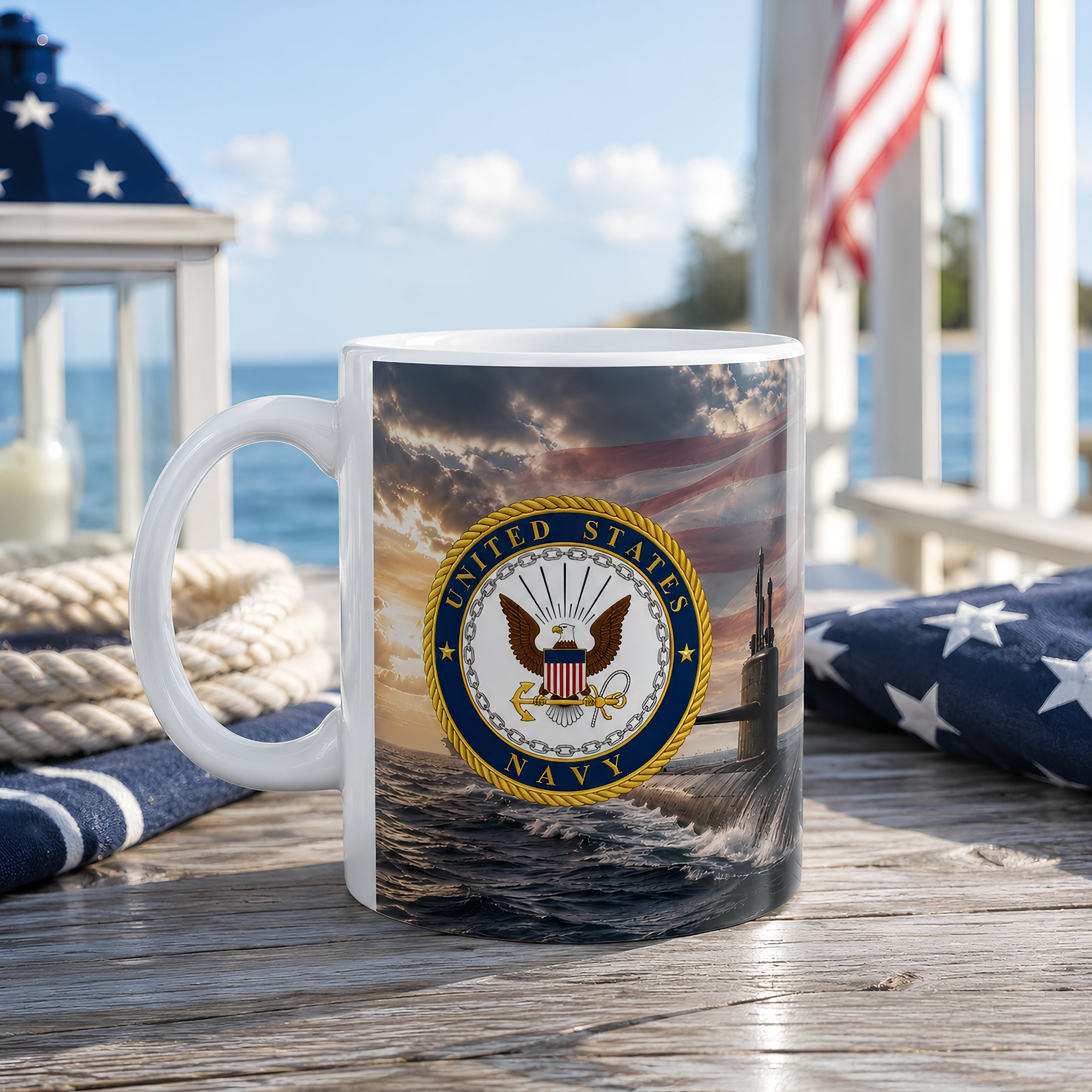 A mug with a design featuring the United States Navy seal, placed on a wooden surface with a view of the ocean and a flag in the background.