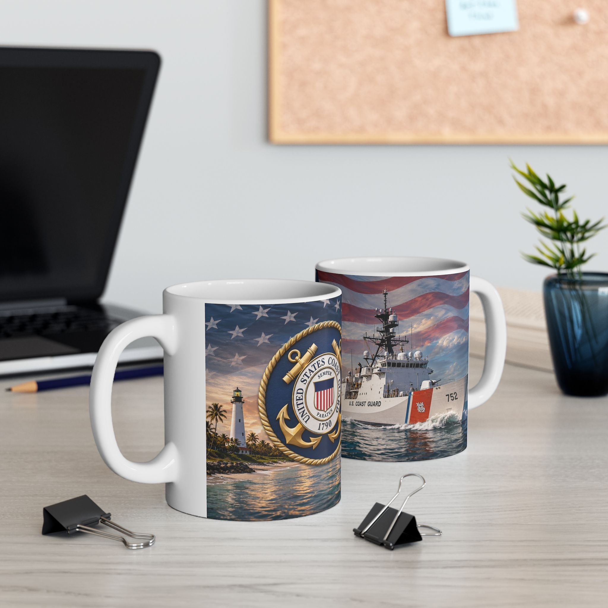 two mugs with naval-themed designs, including a lighthouse and a ship, placed on a desk with a laptop and a plant in the background.