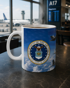 A mug with the United States Air Force seal on it, placed on a table in an airport terminal.