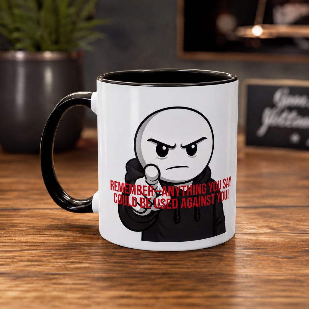 A white mug with a black handle and a cartoon character on it, sitting on a wooden surface.