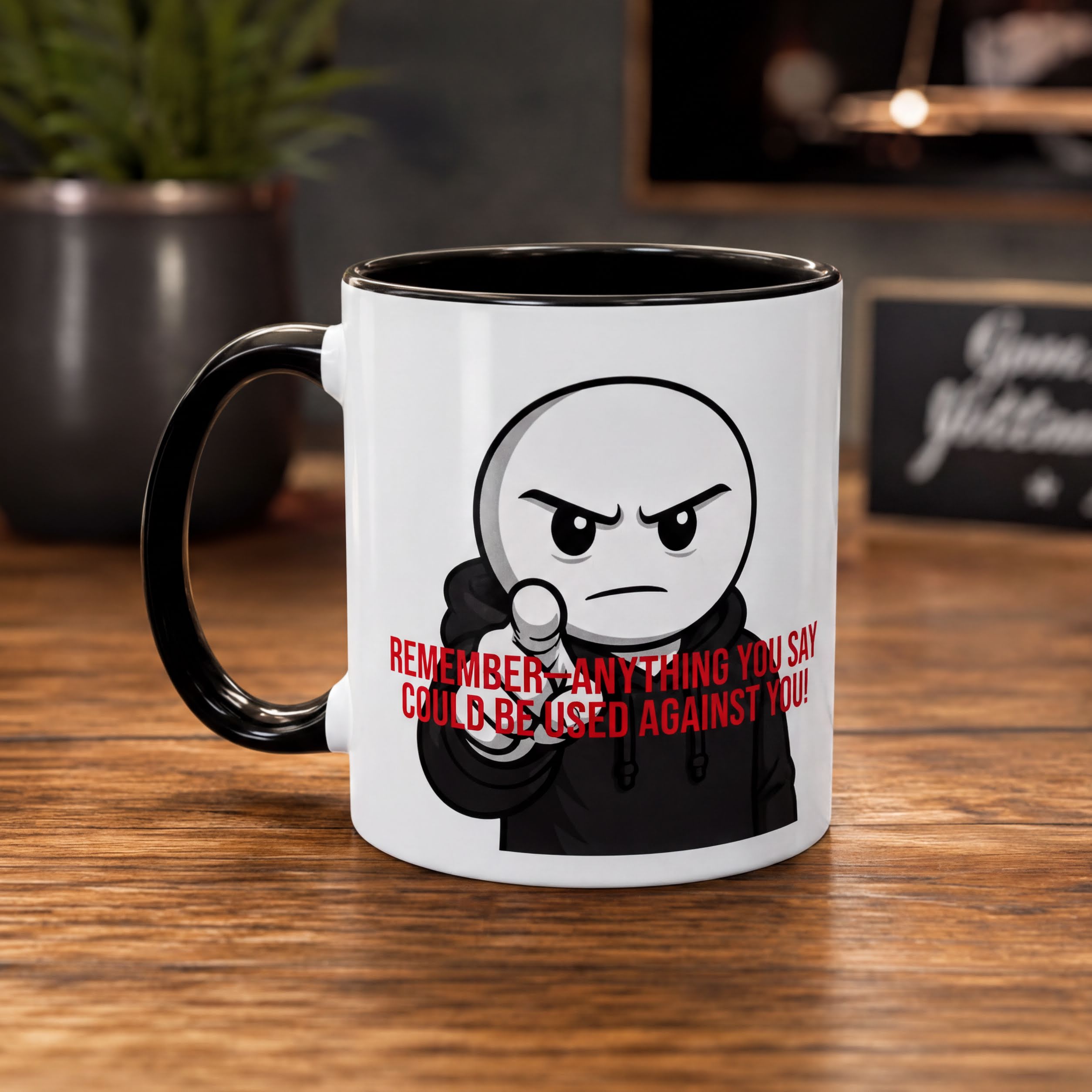 A white mug with a black handle and a cartoon character on it, sitting on a wooden surface.