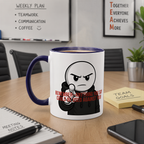 a coffee mug with a cartoon character on it, placed on a wooden table in an office setting. There are also some notes, a smartphone, and a plant visible in the scene.