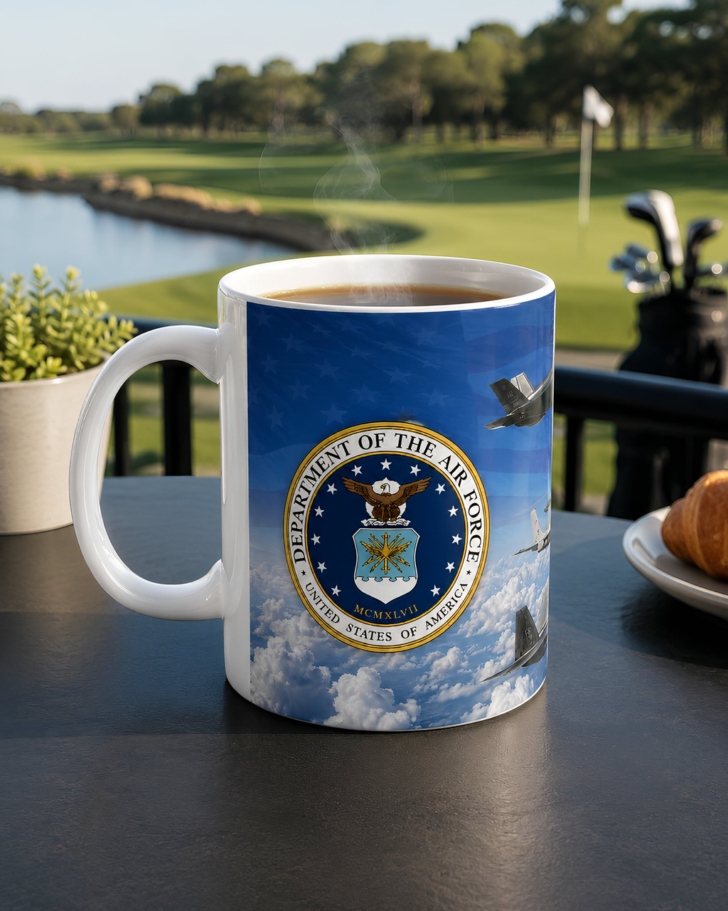 A mug with the United States Air Force seal on it, placed on a table with a golf club and a plate of food in the background.