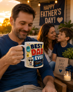 A man holding a mug with a humorous message, while a woman and a child smile and look at him. In the background, there is a banner that reads "Happy Father's Day!".